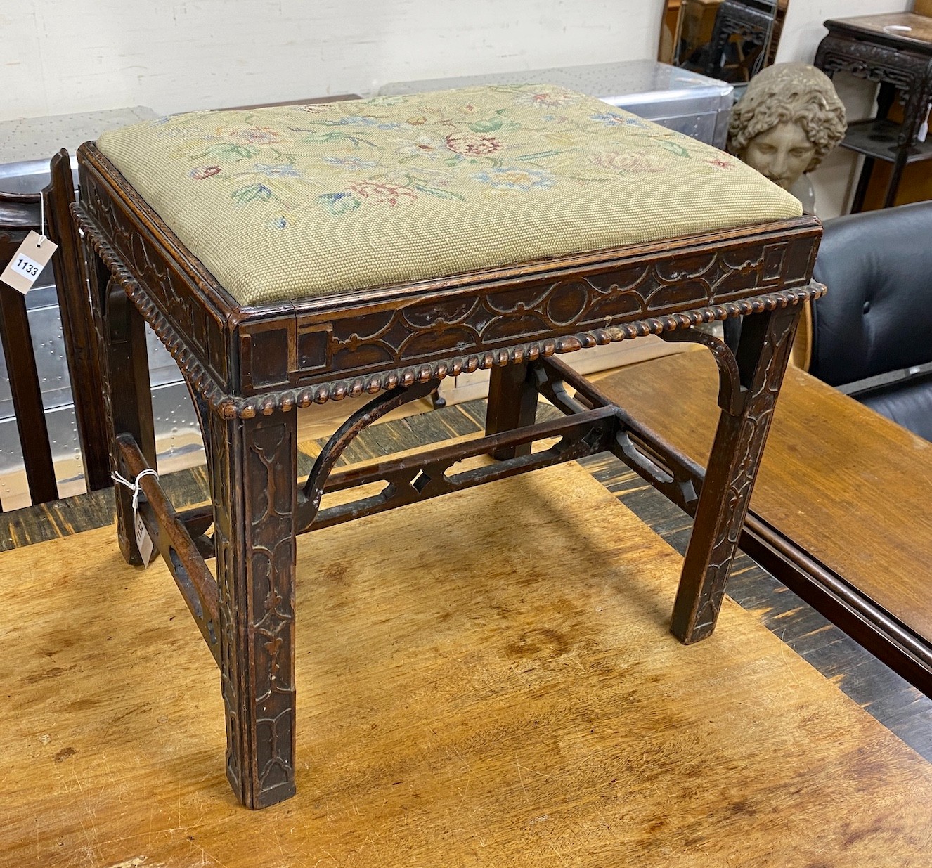 A Chippendale revival mahogany dressing stool with needlework drop in seat and blind fret carving, width 53cm, height 47cm